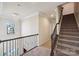 Upstairs hallway featuring decorative chandelier and wooden staircase with carpet at 4027 Wiltshire Ln, Indian Land, SC 29707