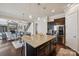 Kitchen island featuring dark cabinets, stainless appliances, granite countertops, and eat-in bar at 4027 Wiltshire Ln, Indian Land, SC 29707