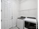 Bright laundry room with washer, dryer, utility sink, and white cabinets for storage at 4027 Wiltshire Ln, Indian Land, SC 29707