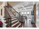 Living room with coffered ceiling, hardwood floors, fireplace, and staircase with iron balusters at 4027 Wiltshire Ln, Indian Land, SC 29707