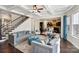 Elegant living room with a staircase, coffered ceilings, and an open view to the kitchen at 4027 Wiltshire Ln, Indian Land, SC 29707