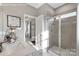 Bright bathroom featuring quartz countertops and a glass-enclosed shower with tile surround at 434 Serenity Cir # F, Cramerton, NC 28032