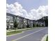 A charming street view of a neighborhood filled with colorful townhomes and tree-lined sidewalks at 434 Serenity Cir # F, Cramerton, NC 28032