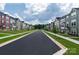 Street view of a community lined with well-manicured lawns, sidewalks, and craftsman-style townhomes at 434 Serenity Cir # F, Cramerton, NC 28032