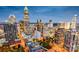 Nighttime aerial view of the Charlotte skyline with illuminated skyscrapers and city lights at 437 Serenity Cir # E, Cramerton, NC 28032