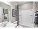 A bathroom featuring a shower-tub combination, framed artwork, and a modern vanity sink at 437 Serenity Cir # E, Cramerton, NC 28032