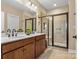 Elegant bathroom featuring double sinks, a large mirror, and a spacious glass-enclosed shower at 473 Bowline Dr, Denver, NC 28037
