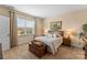 Bright bedroom with a beautiful landscape view, wooden furniture, and soothing neutral walls at 473 Bowline Dr, Denver, NC 28037