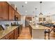 Stylish kitchen featuring granite countertops, stainless steel appliances, a large island, and hardwood floors at 473 Bowline Dr, Denver, NC 28037
