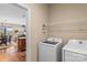 Functional laundry room featuring modern appliances, shelving, and convenient access to the dining area at 473 Bowline Dr, Denver, NC 28037