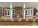 Inviting outdoor space features stone fireplace with seating area and view of french doors at 473 Bowline Dr, Denver, NC 28037