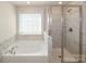 Bathroom features a soaking tub, separate shower, and marble countertops at 4849 Tacoma Dr, Fort Mill, SC 29707