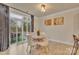 Well-lit dining area with table, modern chairs, light fixture and sliding glass doors to the outdoor patio at 4849 Tacoma Dr, Fort Mill, SC 29707