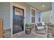 Cozy front porch offers a seating area, a decorative striped rug and a potted plant at 4849 Tacoma Dr, Fort Mill, SC 29707