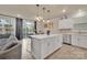 Bright kitchen features a center island, stainless steel appliances, and an adjacent dining area with patio access at 4849 Tacoma Dr, Fort Mill, SC 29707