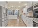 Bright kitchen featuring stainless steel appliances, white cabinetry, and an island with countertop seating at 4849 Tacoma Dr, Fort Mill, SC 29707