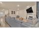 Open concept living room boasts a fireplace, grey sofa, and wood-look flooring at 4849 Tacoma Dr, Fort Mill, SC 29707