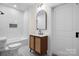 Bathroom with a wooden vanity and hexagon tile floor at 49 8Th Se St, Hickory, NC 28602