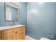Modern bathroom with a wood vanity and blue walls at 49 8Th Se St, Hickory, NC 28602