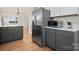 Gray kitchen cabinets, stainless steel appliances and white countertops at 49 8Th Se St, Hickory, NC 28602