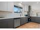Modern kitchen with gray cabinets, white subway tile backsplash and stainless steel appliances at 49 8Th Se St, Hickory, NC 28602