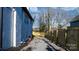 Gravel driveway and wooden fence bordering the side yard at 49 8Th Se St, Hickory, NC 28602