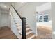 Elegant staircase with wooden steps and a modern black and white railing that creates a grand entrance at 49 8Th Se St, Hickory, NC 28602
