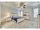 Spacious bedroom with a ceiling fan, cozy carpeting, and a beautifully coordinated bedspread at 520 Crawfish Dr, Fort Mill, SC 29708
