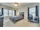 Comfortable bedroom with two windows, neutral walls, and plush carpet at 520 Crawfish Dr, Fort Mill, SC 29708