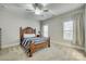 Bright bedroom featuring many windows, ceiling fan, and a beautiful bed at 520 Crawfish Dr, Fort Mill, SC 29708