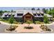 Wide shot of the beautiful community clubhouse with stone and timber accents and manicured landscaping at 520 Crawfish Dr, Fort Mill, SC 29708
