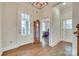 Elegant foyer with hardwood floors, a decorative light fixture and ample natural light at 520 Crawfish Dr, Fort Mill, SC 29708