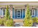 Inviting front porch showcasing stone columns, a stylish front door, and manicured greenery at 520 Crawfish Dr, Fort Mill, SC 29708