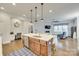 Open-concept living room with kitchen island and ample natural light, creating a welcoming atmosphere at 520 Crawfish Dr, Fort Mill, SC 29708