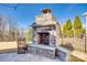 Outdoor stone fireplace with seating area, perfect for cozy evenings in the backyard at 520 Crawfish Dr, Fort Mill, SC 29708
