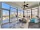 Bright sunroom featuring large windows, tile floors, and comfortable seating with a view of the backyard at 520 Crawfish Dr, Fort Mill, SC 29708
