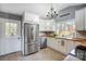 Well-lit kitchen with white cabinets, updated appliances, and a functional layout at 6017 Caroline Dr, Matthews, NC 28104