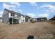 Expansive backyard view showcasing fire pit area, screened-in porch, and home exterior at 7019 Lenton Rd, Charlotte, NC 28215