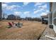 Spacious backyard featuring an outdoor fire pit with chairs, perfect for cool nights and entertaining at 7019 Lenton Rd, Charlotte, NC 28215