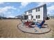 Large backyard with a fire pit and colorful Adirondack chairs, great for outdoor entertaining at 7019 Lenton Rd, Charlotte, NC 28215