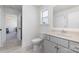 Neutral-toned bathroom features a white toilet, vanity, and doorway to an adjoining shower at 7019 Lenton Rd, Charlotte, NC 28215
