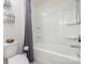 Bathroom features a shower-tub, white toilet, towel rack, and gray shower curtain at 7019 Lenton Rd, Charlotte, NC 28215