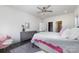 Light-filled bedroom features hardwood floors, a ceiling fan, and ensuite bath and closet at 7019 Lenton Rd, Charlotte, NC 28215