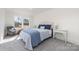 Bright bedroom features neutral walls, gray carpet, and a cottage-style bed and side table at 7019 Lenton Rd, Charlotte, NC 28215