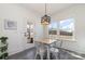 Cozy dining area with modern lighting, a view of the outdoors, and a door leading to the patio at 7019 Lenton Rd, Charlotte, NC 28215