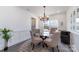 Charming dining room with a glass-top table, upholstered chairs, and an elegant chandelier at 7019 Lenton Rd, Charlotte, NC 28215