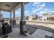 Covered front porch with stone pillars, offering neighborhood views and a relaxing outdoor seating space at 7019 Lenton Rd, Charlotte, NC 28215