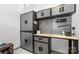 Well-organized garage featuring a workbench, cabinets, pegboard for tools, and a work light at 7019 Lenton Rd, Charlotte, NC 28215