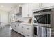 Modern kitchen featuring stainless steel oven, white cabinets, quartz countertop, and subway tile backsplash at 7019 Lenton Rd, Charlotte, NC 28215
