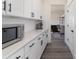 Bright kitchen area with a microwave, ample counter space, and access to dining room at 7019 Lenton Rd, Charlotte, NC 28215